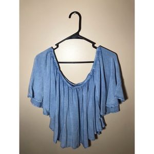 Off the shoulder blue shirt.